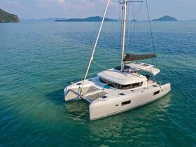 A stunning aerial view of a sleek catamaran gliding through crystal-clear waters, perfect for exploring tropical destinations.