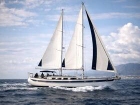 A beautiful sailboat glides through the water, showcasing its elegant sails and sleek design — perfect for sailing enthusiasts and ocean adventures.