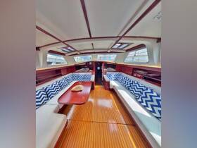 Interior view of a spacious boat cabin featuring comfortable seating and stylish decor, perfect for relaxing during your nautical adventures.