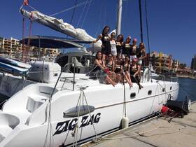 A lively group of friends celebrates aboard the Zig Zag yacht, enjoying a sunny day at the marina — perfect for memorable outings and gatherings.