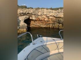 A view from the bow of a boat showcasing a stunning rocky coastline, perfect for exploring hidden coves and enjoying scenic marine landscapes.