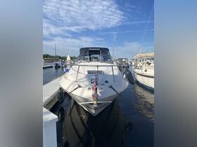 A striking view of a yacht docked at the marina, showcasing its sleek design against a backdrop of clear blue skies.