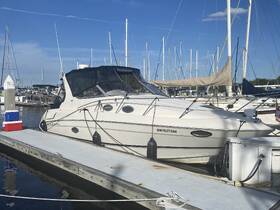 A sleek yacht docked at the marina, showcasing its elegant design against a backdrop of masts and blue skies — perfect for leisurely outings on the water.