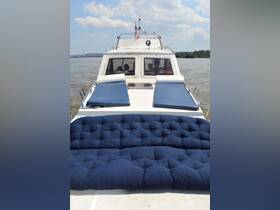A cozy seating area on a boat, featuring comfortable cushions and a view of the water, perfect for relaxing during a day on the water.