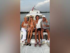 A joyful family enjoys their time on a boat, celebrating with drinks and smiles, perfect for creating lasting memories on the water.