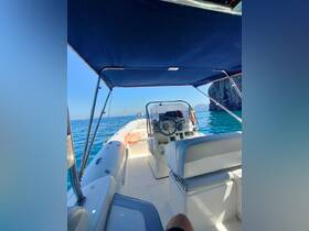 A view of the helm area inside a boat, showcasing the console and seating, perfect for navigating the beautiful waters.