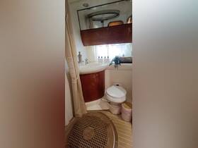 A well-appointed bathroom inside a boat, featuring modern amenities and a stylish design, perfect for comfort during your maritime adventures.