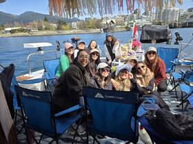 A joyful group of friends enjoys a day on the water aboard a pontoon, celebrating together with laughter and scenic views in the background.