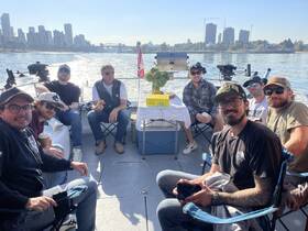 A lively group of friends enjoys a day on the water, surrounded by a stunning cityscape — perfect for social gatherings and celebrations.