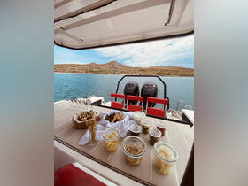 An inviting spread of snacks and drinks is beautifully arranged on the deck of a boat, perfect for enjoying a day on the water.