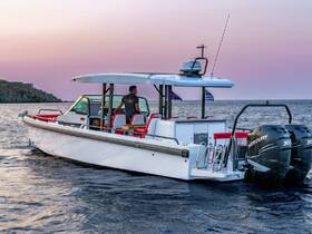 A sleek speedboat navigates the tranquil waters at sunset, showcasing its modern design and spacious seating — perfect for private charters or leisurely cruises.