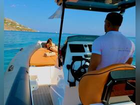 A woman relaxes on the deck of a boat while a captain navigates through the stunning Greek waters, showcasing the perfect blend of leisure and adventure.