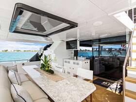 A beautifully designed interior of a luxury yacht featuring a spacious dining area with elegant seating and a stunning view of the water, perfect for entertaining guests.