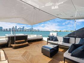 A stylish lounge area on a luxury yacht, featuring comfortable seating and a stunning view of the city skyline — perfect for relaxing while enjoying the water.