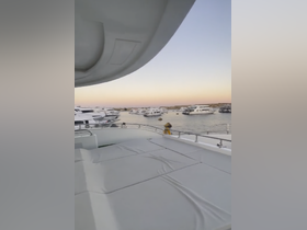 A serene view from the deck of a yacht overlooking a marina filled with boats, perfect for capturing the essence of luxury boating experiences.