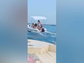 A lively group enjoys a day out on the water aboard a small boat, showcasing the fun and excitement of summer boating adventures.