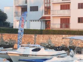 A serene view of a docked boat with a 'Rent a Boat' banner, showcasing a perfect spot for boat rentals near a residential area.