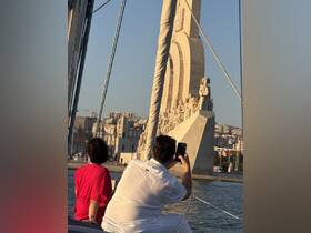 A couple enjoys a scenic view from their boat, capturing the stunning monument in the background — a perfect moment for sightseeing and photography on the water.