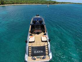A stunning aerial view of the luxurious yacht 'DAYA' anchored in crystal-clear waters, showcasing its elegant design and spacious deck, perfect for relaxation and leisure.