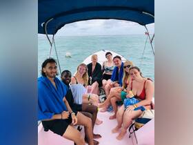 A lively group of friends enjoys their time on a boat, ready for an adventure in the water. Perfect for capturing the joy of shared experiences on the sea.