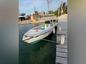 A speedboat named 'Sweet P' docked at a marina, showcasing its sleek design against a tranquil water backdrop.