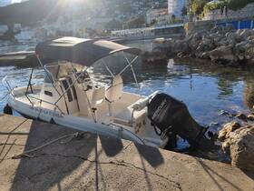 A sleek speedboat named 'La Strada' docked at the harbor, showcasing its stylish design and ready for adventure on the water.
