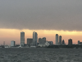 A stunning sunset view of the city skyline reflecting on the water, perfect for capturing the beauty of urban waterfronts.