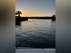 A serene sunset view over a tranquil waterway, perfect for capturing the beauty of nature during a boating adventure.