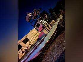 A sleek boat is showcased at night, highlighting its structure and design, perfect for fishing or leisure activities.