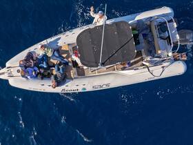 A lively group enjoys their time aboard a Scout boat, capturing moments of fun and camaraderie on the open ocean.