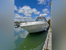 A sleek yacht docked at the marina, showcasing its elegant design against a backdrop of blue skies and calm waters.