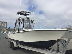 A sleek fishing boat is docked and ready for adventure, showcasing its sturdy design and features at the marina.