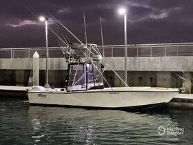 A sleek speedboat docked at night, illuminated by nearby lights, showcasing its fishing gear and ready for the next adventure.