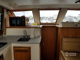 Interior view of a boat's kitchen area featuring a microwave and sink, showcasing the cozy cabin space ideal for meal preparation while on the water.