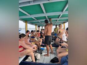 A lively group prepares for a snorkeling adventure aboard a boat, showcasing the excitement of water activities and camaraderie among friends.