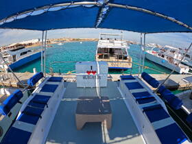 Interior view of a boat lounge area featuring comfortable seating and a scenic backdrop of the marina — perfect for relaxing before setting sail.