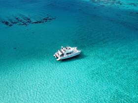 A stunning aerial view of a yacht cruising through crystal-clear turquoise waters, perfect for exploring beautiful destinations.