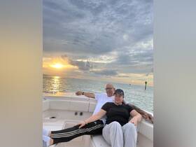 A couple enjoys a romantic moment on a boat at sunset, creating the perfect backdrop for memorable experiences on the water.