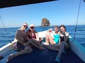 A joyful family enjoys a sunny day on the boat, capturing fun moments against a beautiful ocean backdrop. Perfect for family outings and adventures on the water.