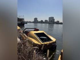 A sleek yellow speedboat docked along the riverbank, with a vibrant city skyline in the background, showcasing a perfect blend of urban life and water adventures.