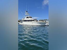 A stunning yacht docked in the marina, showcasing its sleek design against a clear blue sky — perfect for luxury charters and fishing trips.