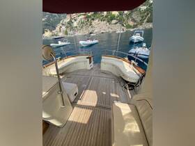 A spacious interior view of a yacht's seating area, showcasing comfortable lounge space and elegant design, perfect for relaxing while enjoying the scenic coastal views.