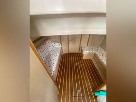 Interior view of a boat cabin featuring comfortable seating and elegant wooden flooring, perfect for relaxing during your nautical adventures.