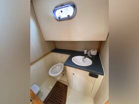 Interior view of a boat bathroom featuring a toilet and sink, designed for comfort and convenience while at sea.