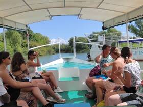 A lively group enjoys a relaxing boat ride, capturing moments of friendship and fun on the water.