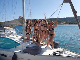 A lively group of women celebrates on a yacht, showcasing fun and friendship under the sun — perfect for bachelorette parties or summer getaways.