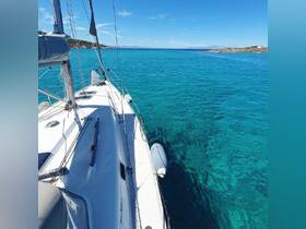 A stunning view of a sailboat gliding through crystal-clear turquoise waters, showcasing the beauty of a serene sailing experience.