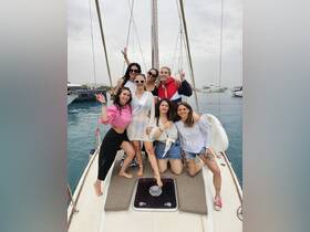 A lively group of friends celebrates aboard a yacht, perfect for bachelorette parties and memorable outings on the water.