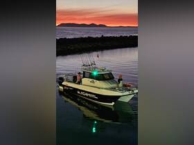 A fishing boat named 'Black Pearl' is anchored at sunset, with two people on board, creating a picturesque scene perfect for evening fishing adventures.