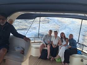 A group of friends enjoys drinks aboard a boat, capturing the essence of a joyful celebration on the water.